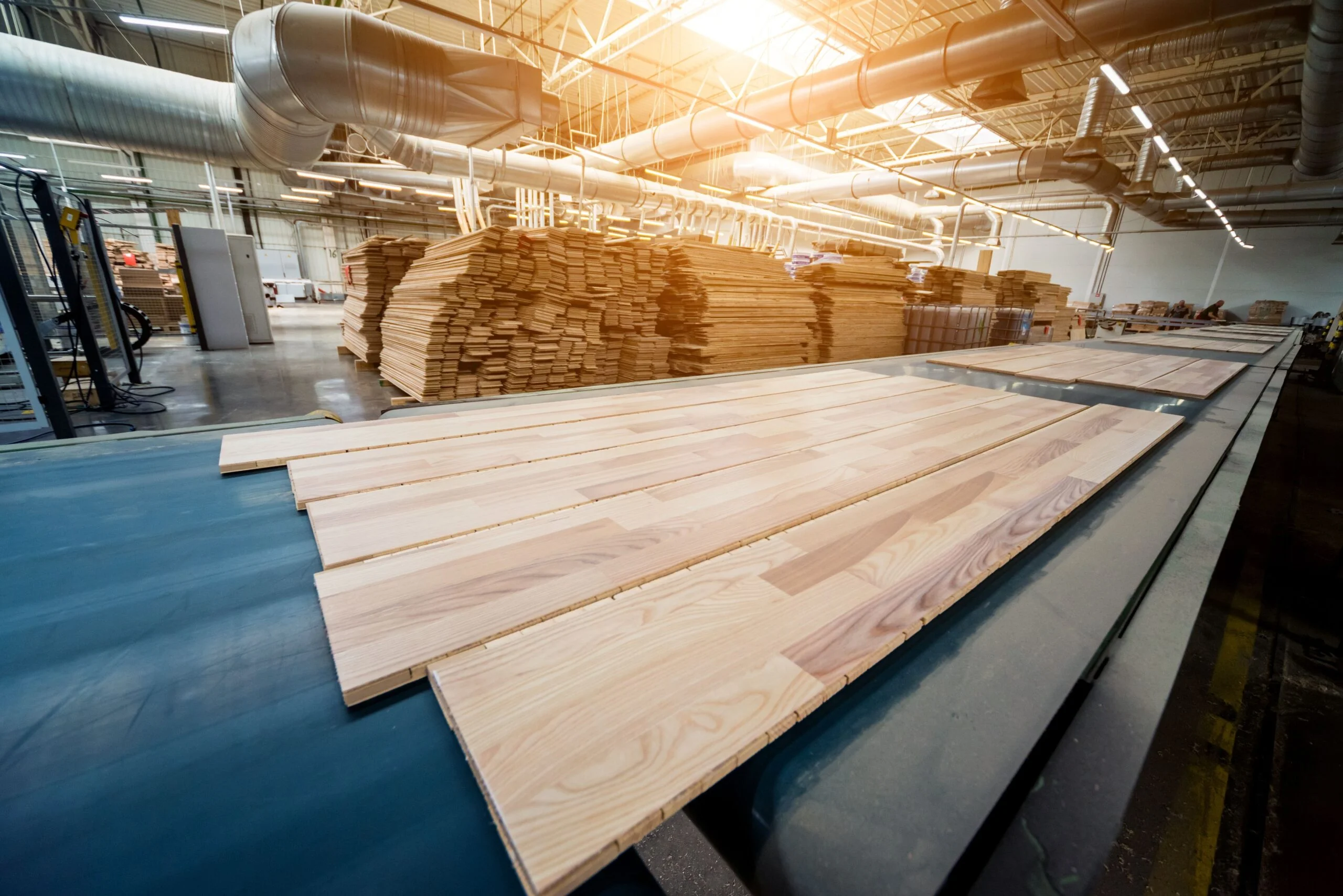Woodworking facility with stacked lumber and overhead dust collection ductwork